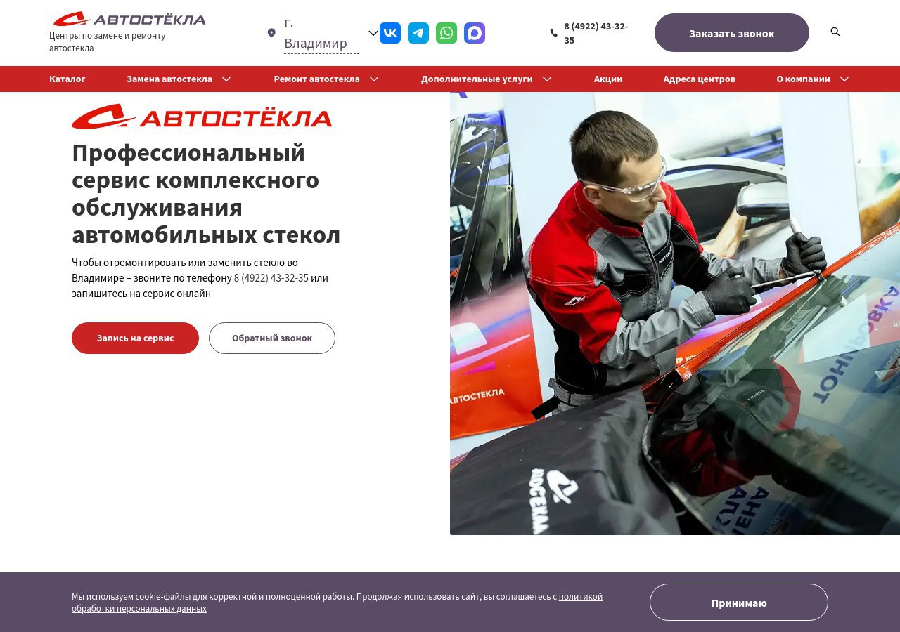 Мастер устанавливает новое лобовое стекло на автомобиль в автосервисе